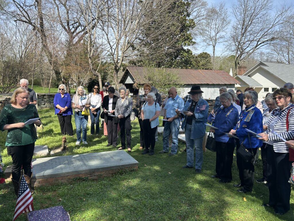 Attendees listen to Stephanie Nelson at the William Hooper family plot.